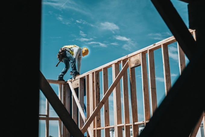 photo of construction worker framing a new house